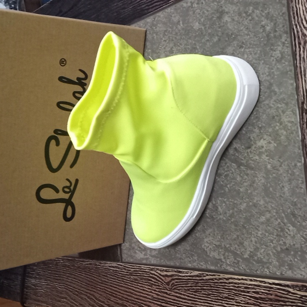 Green platform tennis shoes on the back